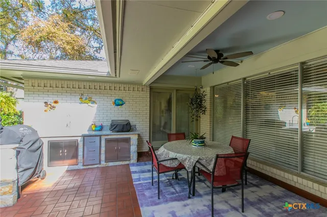 a view of a house with backyard and a tree
