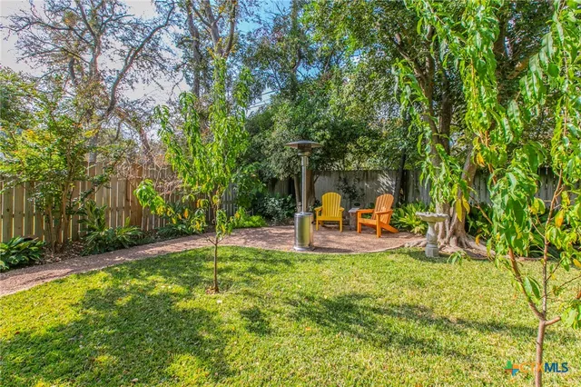 a backyard of a house with outdoor seating and green space