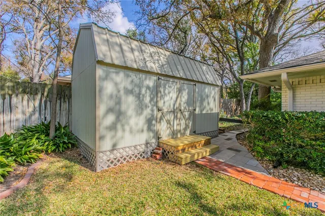 an aerial view of a houses with a yard