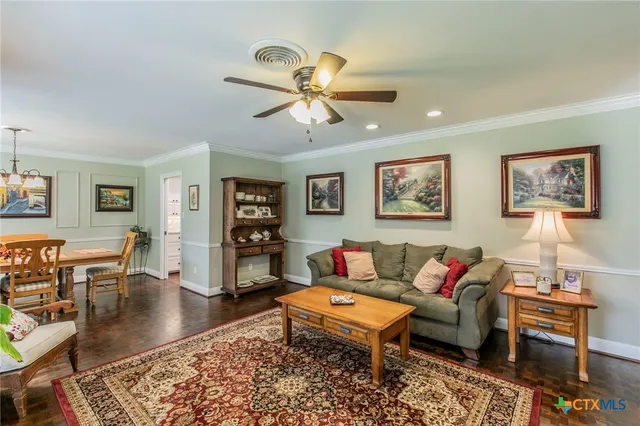 a living room with furniture a rug and a window