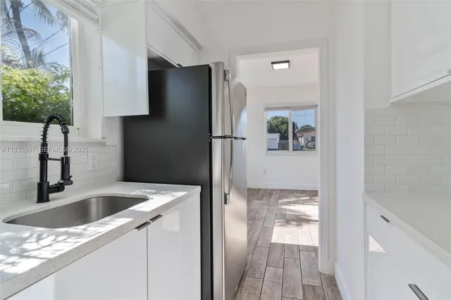 a kitchen with a refrigerator and a sink