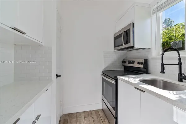 a kitchen with a microwave and a sink