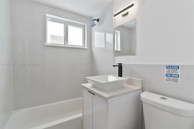 a bathroom with a sink a toilet and a bathtub