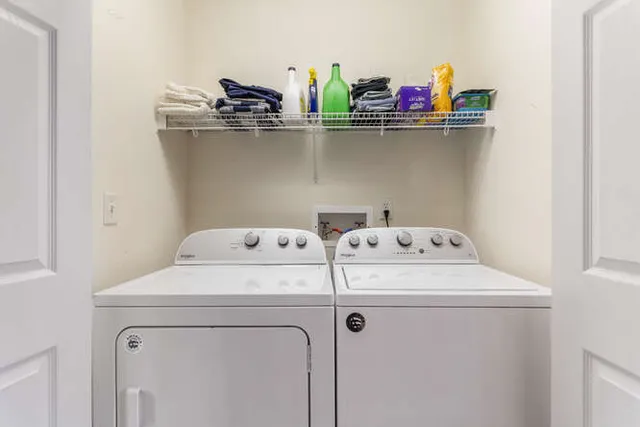 a bedroom with a bed and painting on the wall