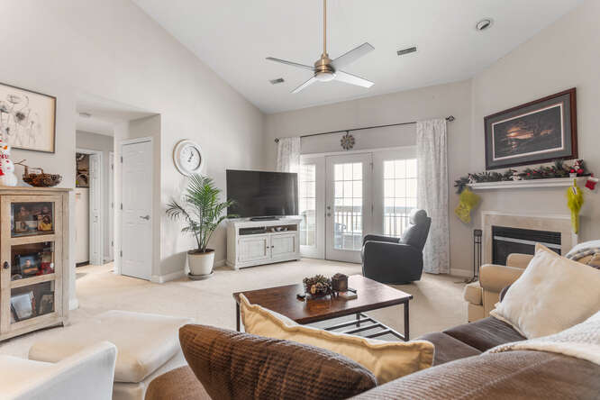 3761 Thornhill Circle Champaign, IL 61822 - Photo 4 of 18 a living room with furniture a flat screen tv and a fireplace