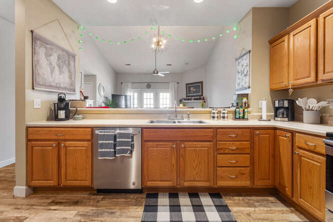 3761 Thornhill Circle Champaign, IL 61822 - Photo 7 of 18 a kitchen with stainless steel appliances granite countertop a sink a stove a refrigerator and island with wooden cabinets