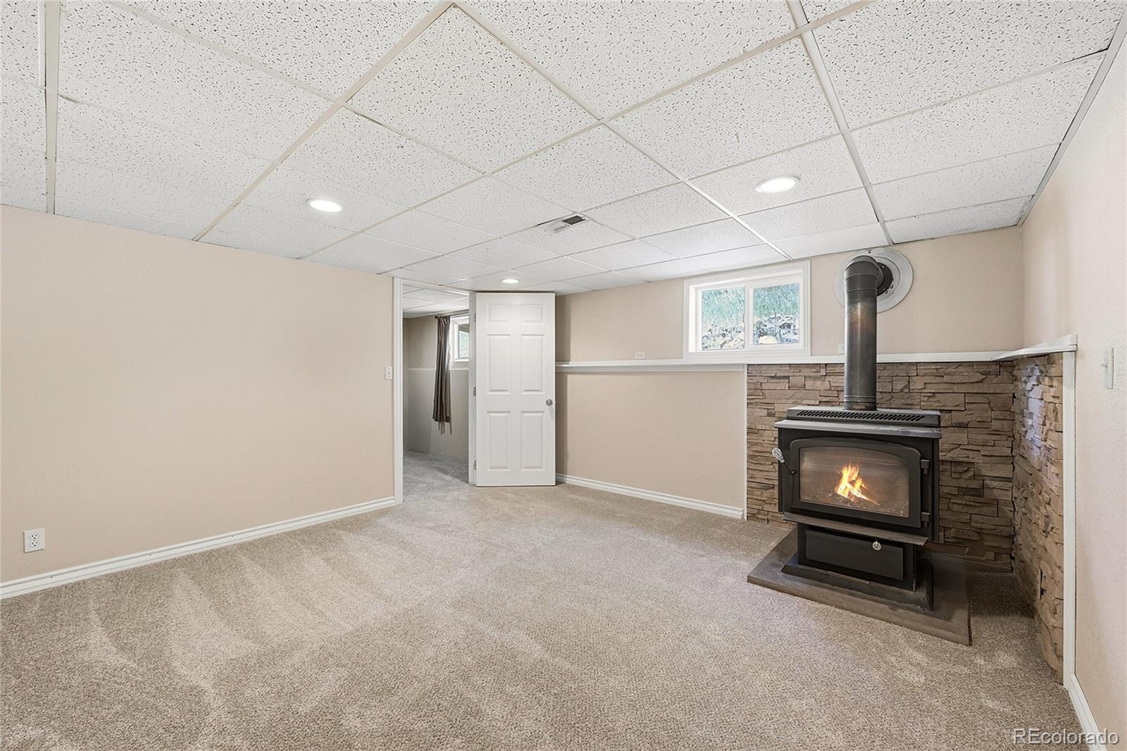 427 Brookside Drive Bailey, CO 80421 - Photo 31 of 37 a view of an empty room with a fireplace