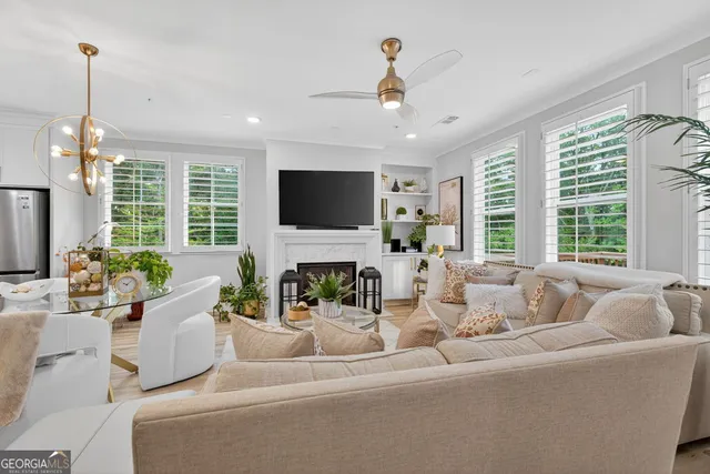 a living room with furniture potted plant and a large window