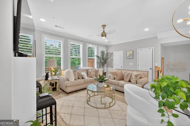 a bedroom with a large bed couch and a large window