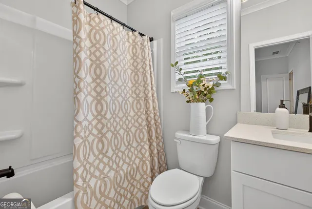 a front view of a house with yard and parking