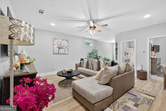 an aerial view of a house with swimming pool large trees and mountain view