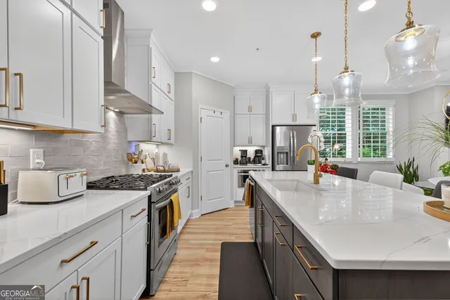 a kitchen with stainless steel appliances kitchen island a refrigerator and a view of living room