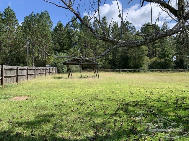3281 Mason Road Walnut Hill, FL 32568 - Photo 12 of 41 a view of a garden with a bench