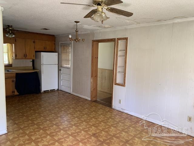 3281 Mason Road Walnut Hill, FL 32568 - Photo 18 of 41 an empty room with a cabinet and a ceiling fan