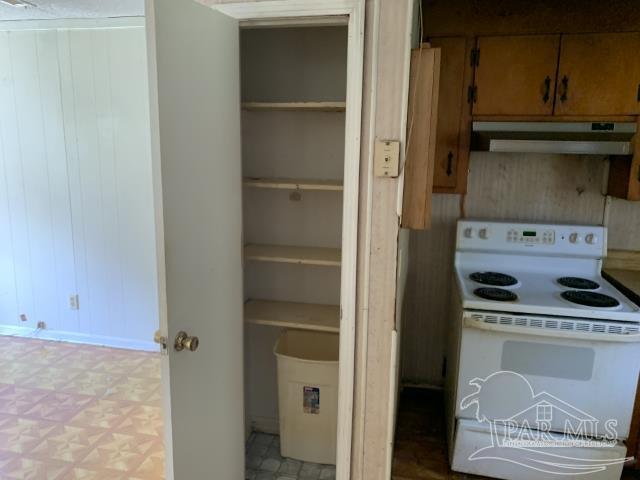 3281 Mason Road Walnut Hill, FL 32568 - Photo 26 of 41 a kitchen with a refrigerator and cabinets