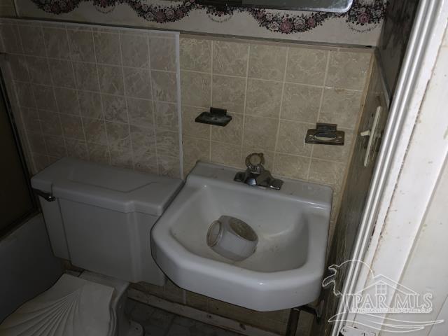 3281 Mason Road Walnut Hill, FL 32568 - Photo 40 of 41 a bathroom with a sink and toilet
