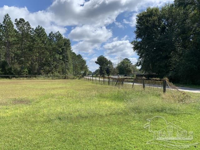 3281 Mason Road Walnut Hill, FL 32568 - Photo 4 of 41 a swimming pool with an outdoor space and seating area