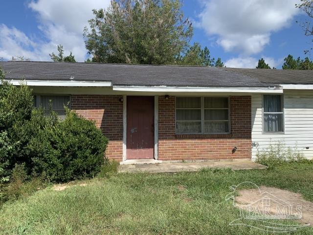 3281 Mason Road Walnut Hill, FL 32568 - Photo 7 of 41 a front view of a house with a yard