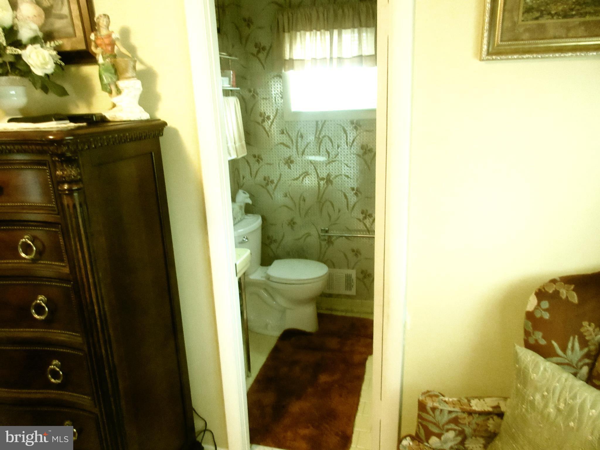 4786 Byron Road Baltimore, MD 21244 - Photo 11 of 30 a bathroom with a toilet and a shower