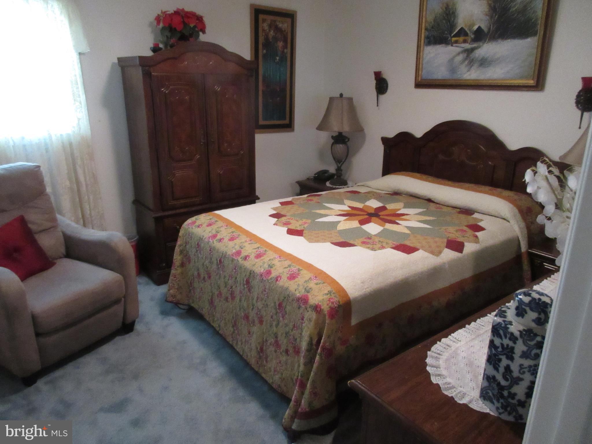 4786 Byron Road Baltimore, MD 21244 - Photo 12 of 30 a bedroom with a bed and a dresser