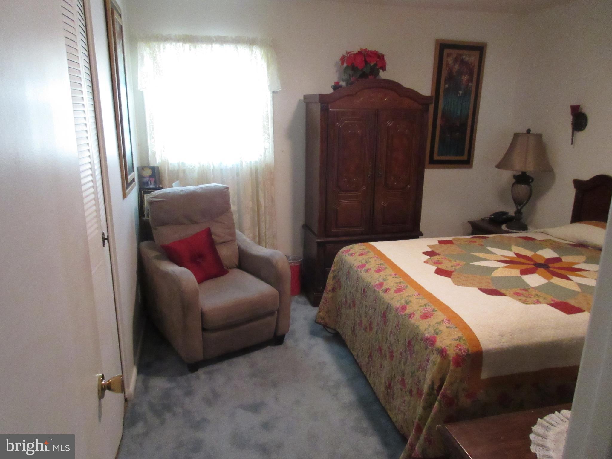 4786 Byron Road Baltimore, MD 21244 - Photo 13 of 30 a bedroom with a bed and a mirror