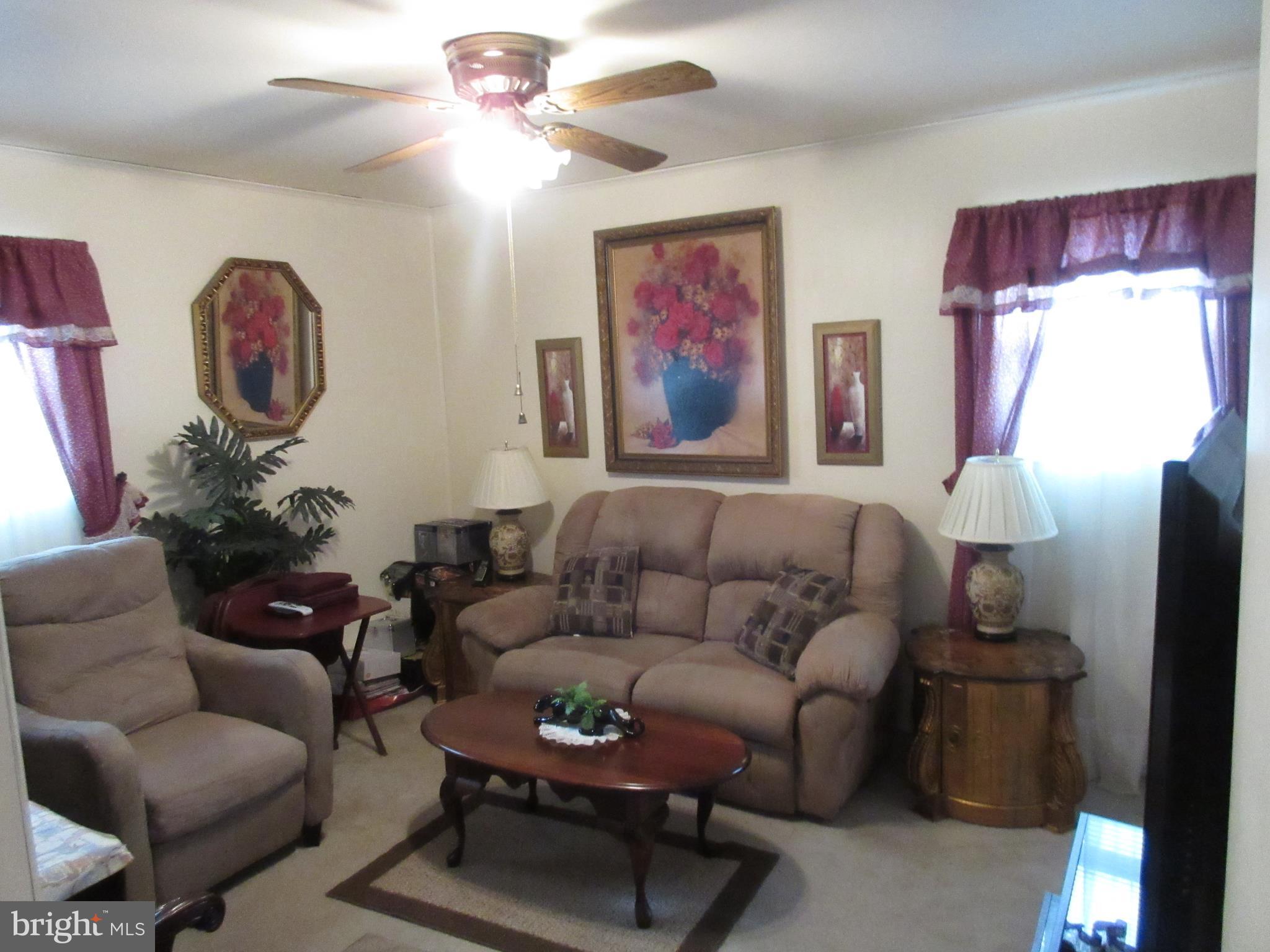4786 Byron Road Baltimore, MD 21244 - Photo 14 of 30 a living room with furniture a chandelier and a window