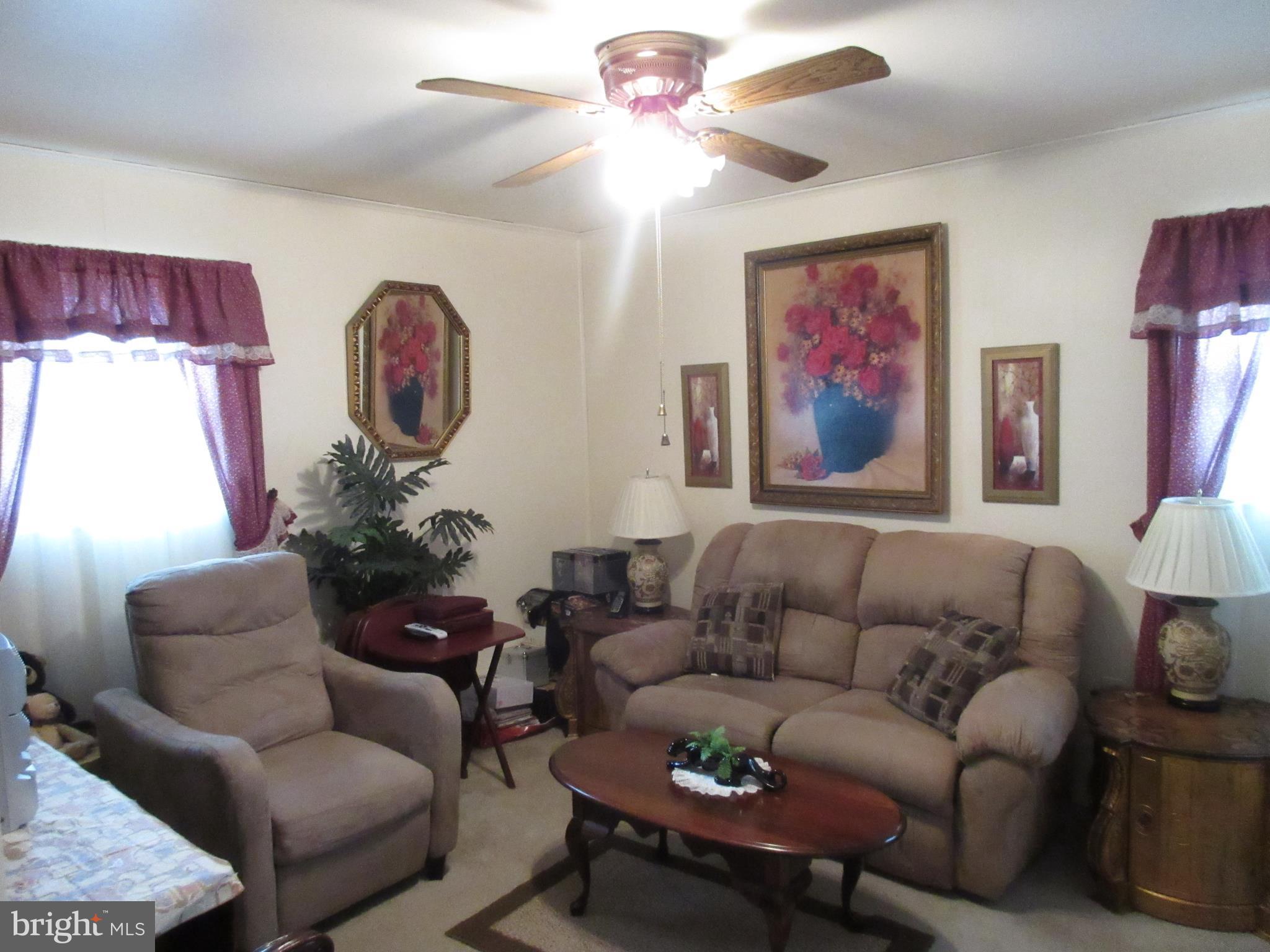 4786 Byron Road Baltimore, MD 21244 - Photo 15 of 30 a living room with furniture a clock and a window