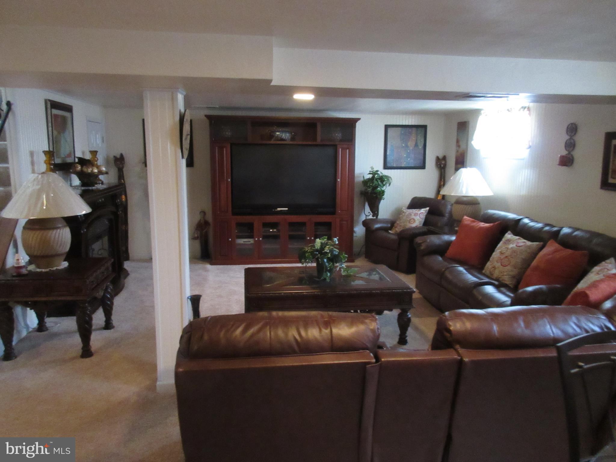 4786 Byron Road Baltimore, MD 21244 - Photo 20 of 30 a living room with furniture and a flat screen tv