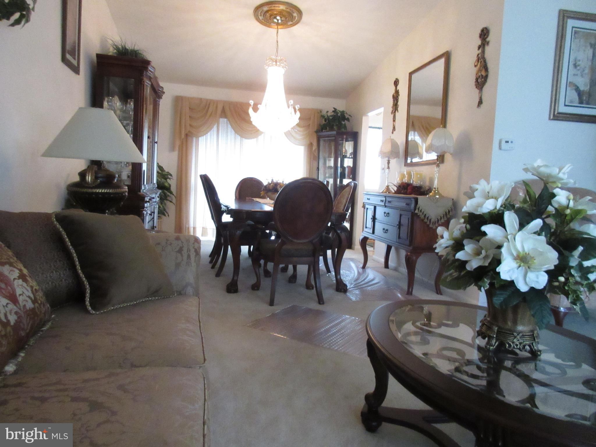 4786 Byron Road Baltimore, MD 21244 - Photo 5 of 30 a living room with furniture a chandelier and a dining table