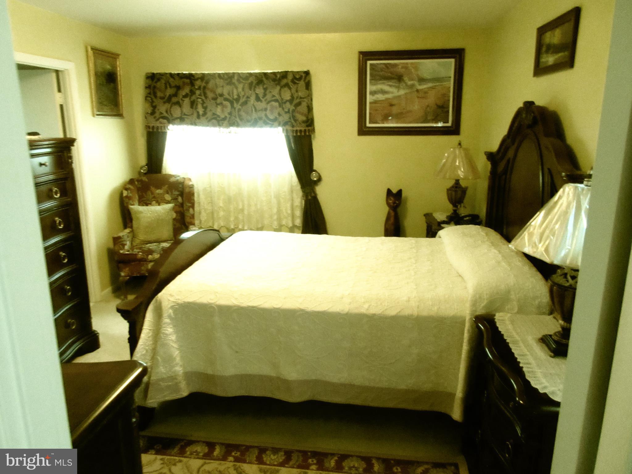 4786 Byron Road Baltimore, MD 21244 - Photo 10 of 30 a bedroom with a bed and wooden floor