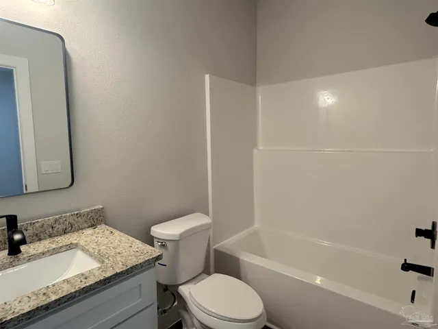 a bathroom with a sink toilet and bathtub