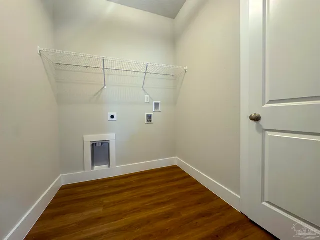 a view of a room with wooden floor