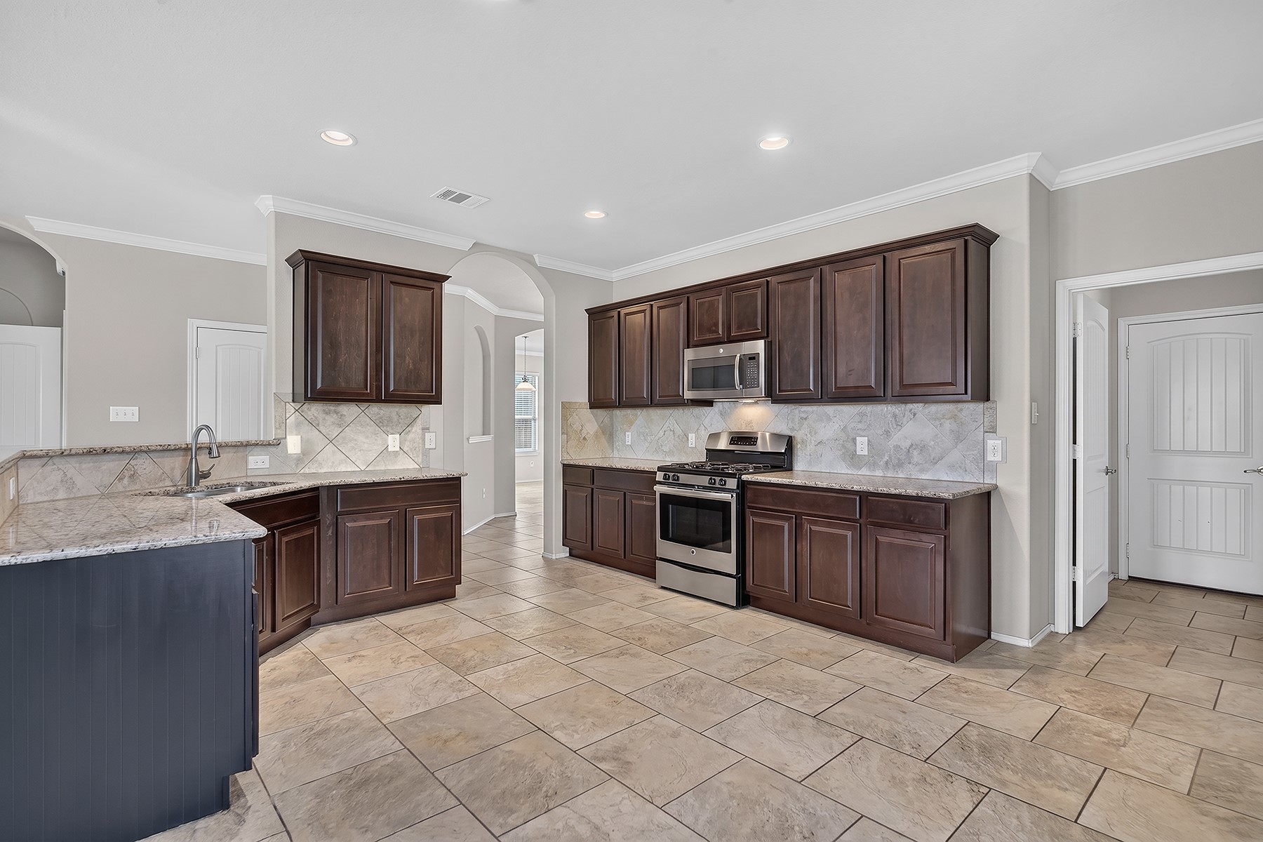 4601 Chestnut Meadows Bend Georgetown, TX 78626 - Photo 8 of 35 A well-appointed kitchen showcasing elegant granite countertops and modern stainless steel appliances.