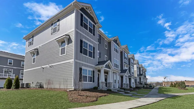 a view of a white house with a yard