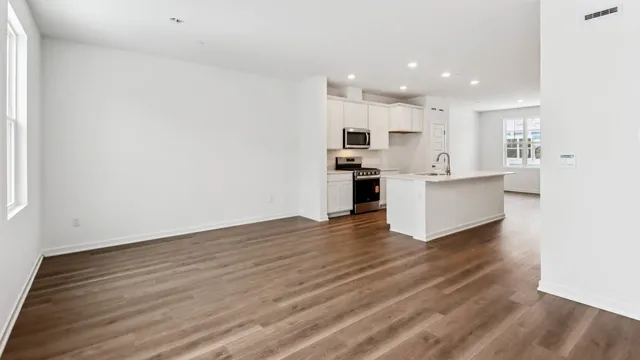 a view of kitchen with wooden floor and electronic appliances