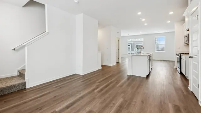 a view of a kitchen with wooden floor and a sink