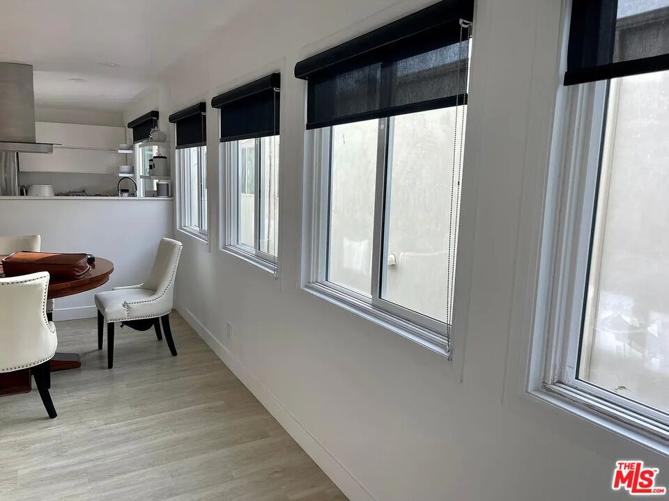 36 Anchorage Street, Unit 1 Venice, CA 90292 - Photo 12 of 32 a hallway with chairs and a window with wooden floor