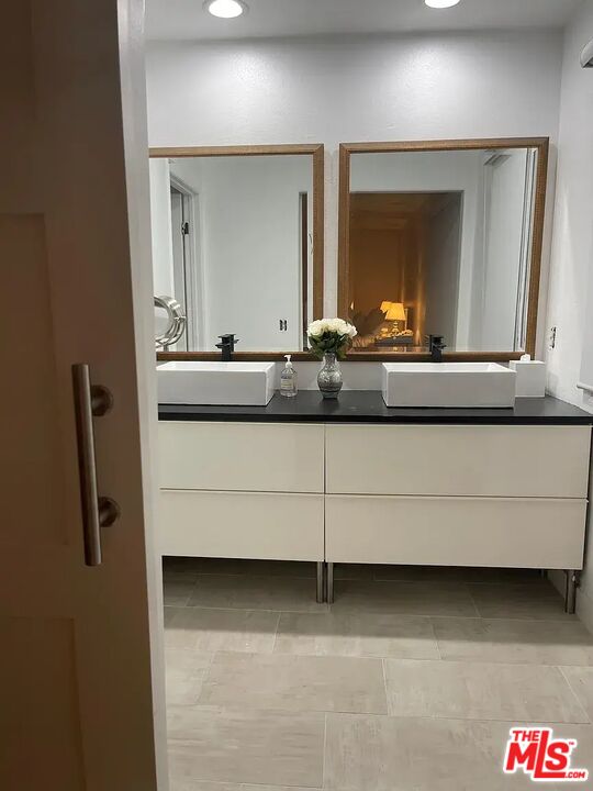 36 Anchorage Street, Unit 1 Venice, CA 90292 - Photo 14 of 32 a bathroom with a double vanity sink and mirror