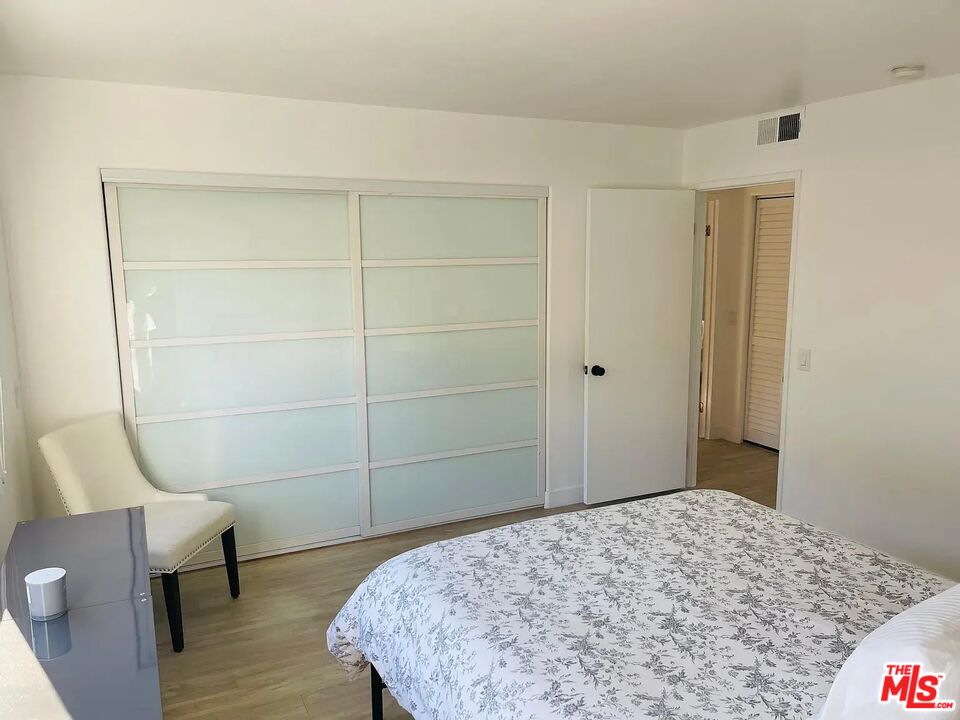 36 Anchorage Street, Unit 1 Venice, CA 90292 - Photo 20 of 32 a bedroom with a bed and wooden floor