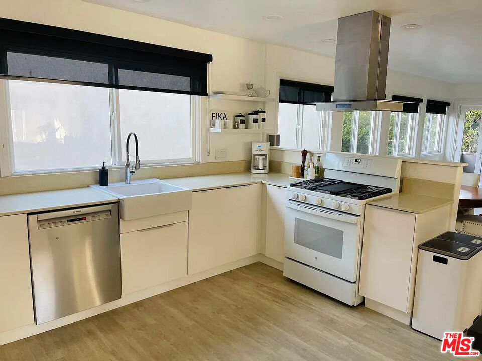 36 Anchorage Street, Unit 1 Venice, CA 90292 - Photo 4 of 32 a kitchen with stainless steel appliances a stove a sink and a microwave
