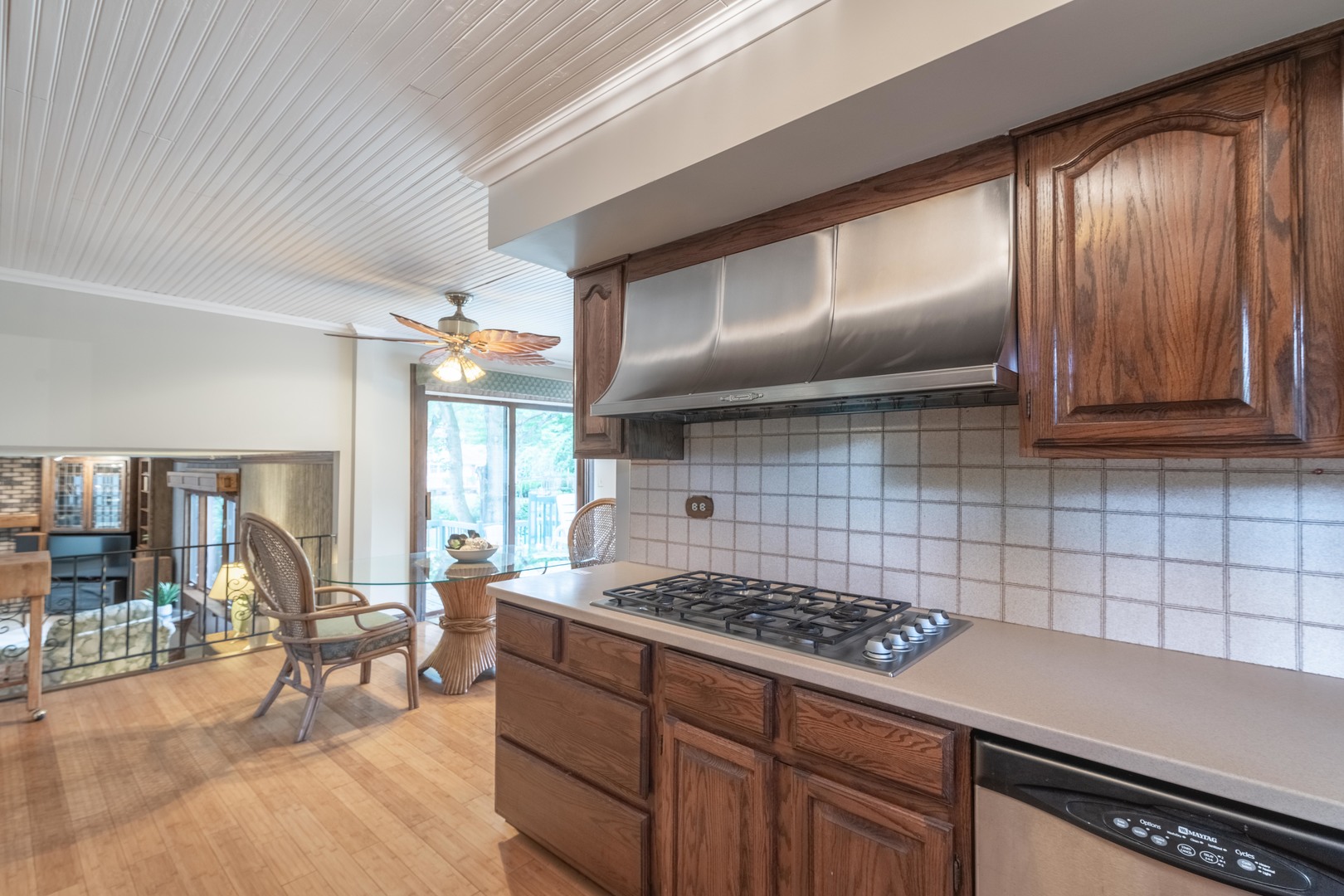7N730 Sycamore Road St. Charles, IL 60175 - Photo 17 of 40 a kitchen with granite countertop a stove a sink and a wooden cabinets