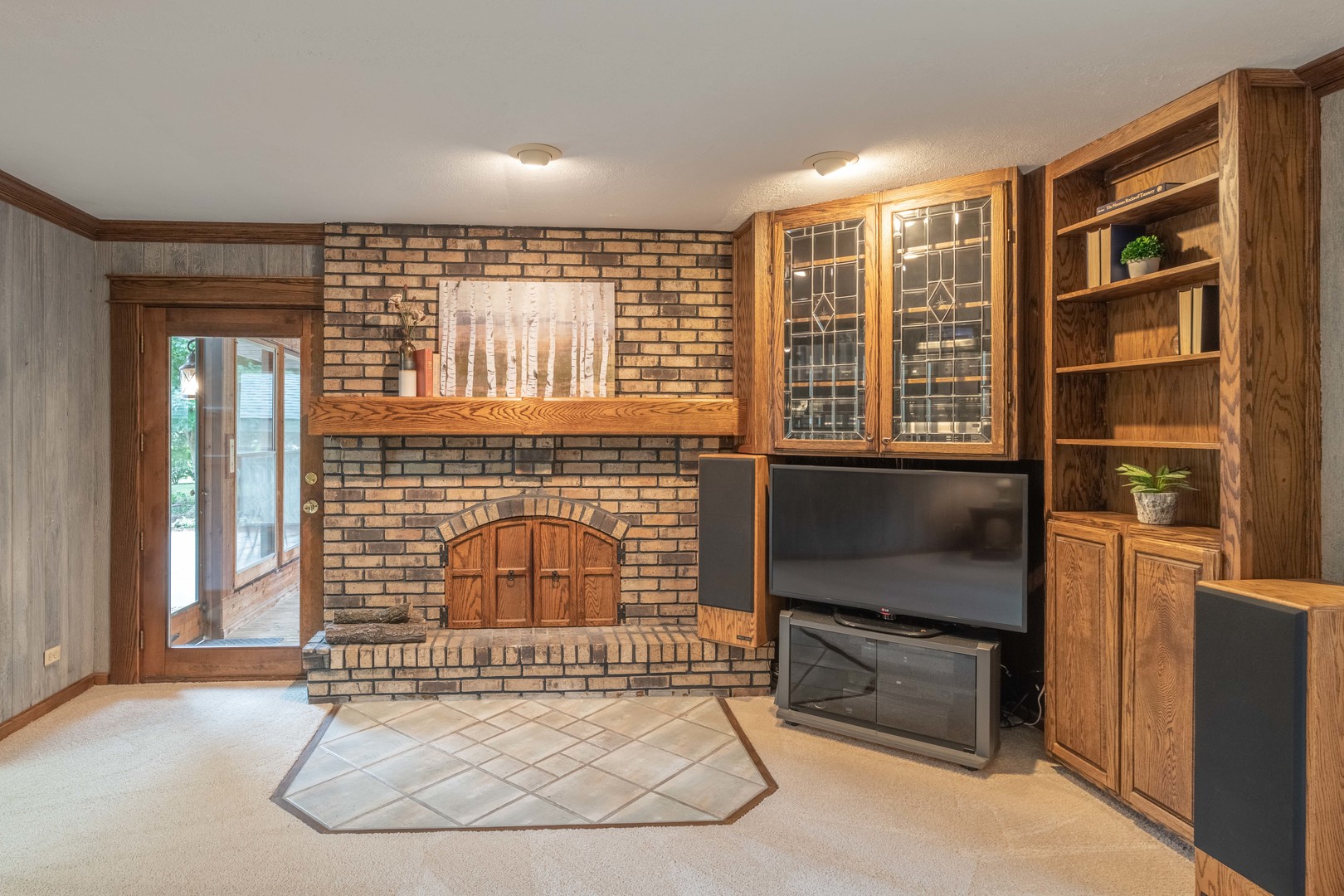 7N730 Sycamore Road St. Charles, IL 60175 - Photo 22 of 40 a living room with furniture a flat screen tv and a fireplace