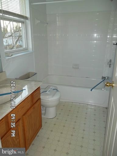 307 Sandy Spring Road Laurel, MD 20707 - Photo 4 of 18 a bathroom with a granite countertop sink a toilet and a shower