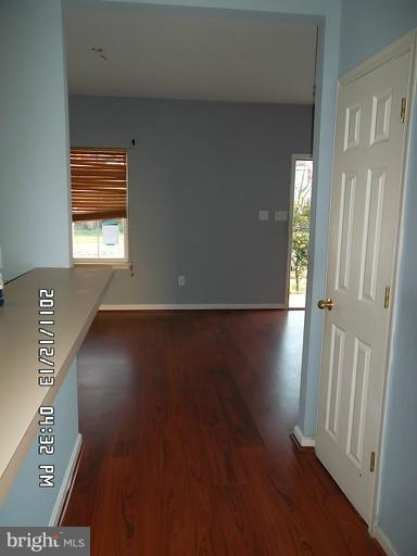 307 Sandy Spring Road Laurel, MD 20707 - Photo 6 of 18 an empty room with wooden floor and windows