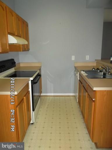 307 Sandy Spring Road Laurel, MD 20707 - Photo 9 of 18 a utility room with a sink a washer and dryer