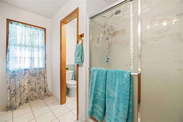a bathroom with a shower and a mirror