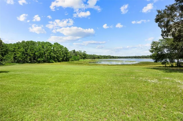 a view of a lake with a house in the background