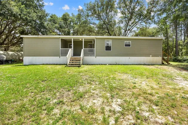 front view of a house with yard and a tree