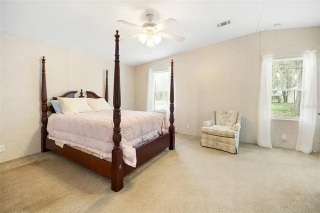 a bedroom with a bed couch and window