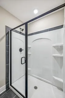 a bathroom with a glass shower door